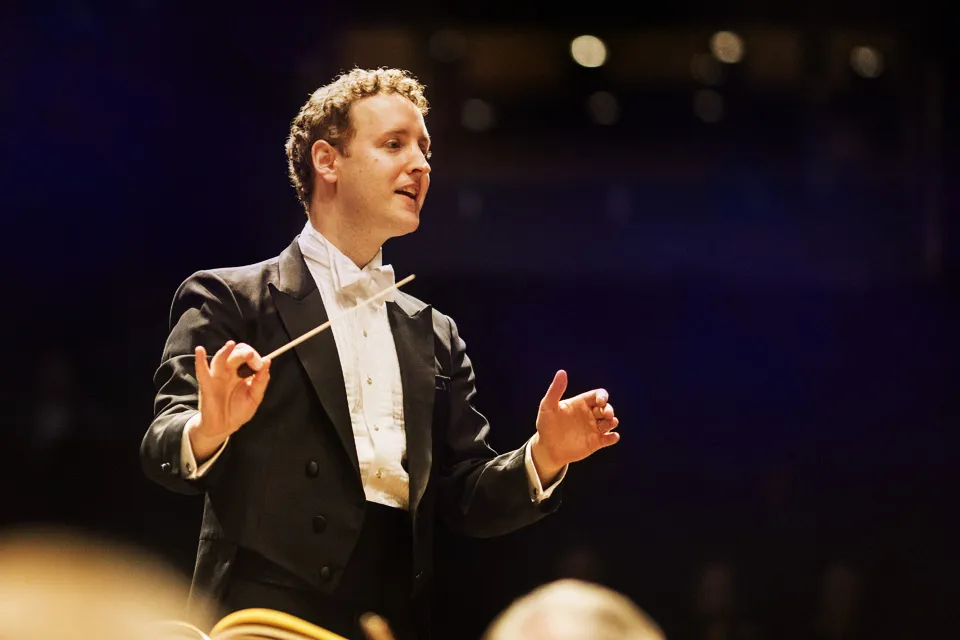 Michael Francis, professional music director and satisfied Coleman Piano Movers client, in formal attire