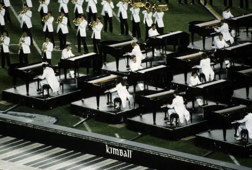 Vintage Kimball upright piano with polished wood finish and classic keyboard layout, representing American piano manufacturing heritage