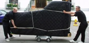 Professional piano moving company in San Ysidro carefully transporting a grand piano with specialized equipment and protective padding